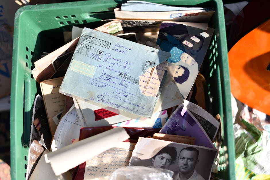 A collection of vintage letters and photographs in an old basket, evoking memories.