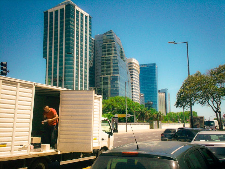 Urban scene in Buenos Aires with skyscrapers and delivery activity on a sunny day.